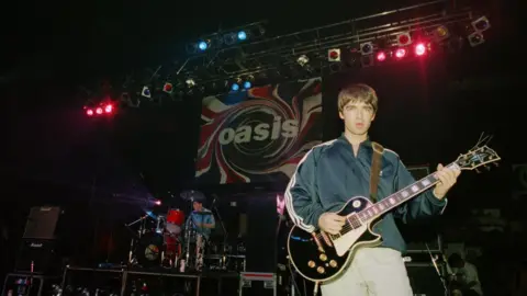 Peter Macdiarmid/Getty Images Noel Gallagher on stage in 1994