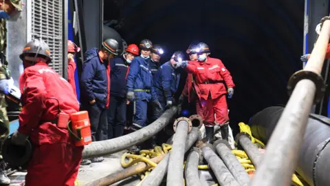 Reuters Rescuers work at the site where a coal mine flooded in Hutubi county