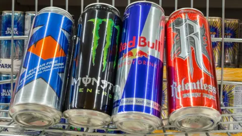 Alamy Four different energy drink brands in a shopping trolley